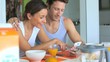 Video: Couple looking at internet while having breakfast Couple looking at internet while having breakfast
