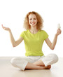 A young woman with an energy-saving bulb, sitting on the floor