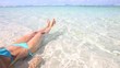 Young woman relaxing in transparent water