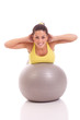 young woman exercising on the big gray ball