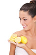 Young woman holding a slice of lemons