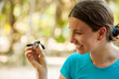 Newly hatched baby turtle in girls hand at Sea Turtles Conservat