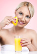 Woman  squeezes the juice from the lemon
