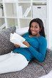 Foto: Smiling black woman reading book Smiling black woman reading book