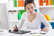 Photo: woman using a graphic tablet and pen woman using a graphic tablet and pen