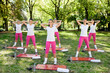 Photo: Group of women doing warm up exercises Group of women doing warm up exercises