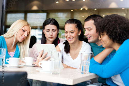 Photo: Group of young people in modern cafe Group of young people in modern cafe