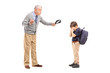 Foto: Angry grandfather holding a belt and shouting at his nephew Angry grandfather holding a belt and shouting at his nephew