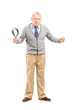 Full length portrait of an angry mature man holding a belt and l