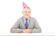 Happy mature gentleman with party hat