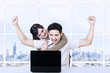 Foto: Happy couple with laptop in office Happy couple with laptop in office