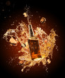 Whiskey splashing around bottler on black background