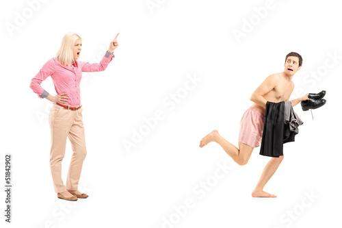 Photo: Full length portrait of a woman shouting at a naked guy running Full length portrait of a woman shouting at a naked guy running