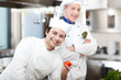 Two chefs in a restaurant's kitchen