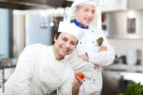 Photo: Two chefs in a restaurant's kitchen Two chefs in a restaurant's kitchen