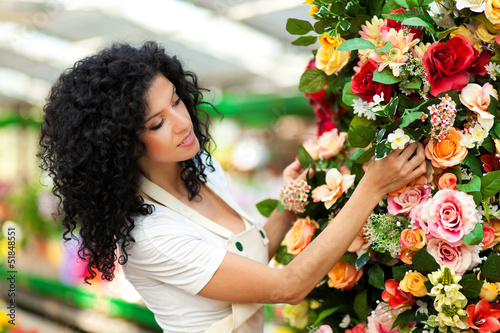 Photo: Female florist in a greenhouse Female florist in a greenhouse