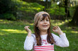 young girl with green eyes playing in outdoors scene