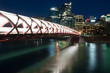 Calgary skyline and pedestrian bridge at night.