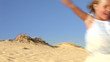 Young Girl Running Down Sand Dune