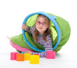 Little girl is playing with colorfull building bricks