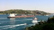 Crude oil tanker sailing with a tug boat through Straits