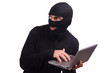 Hacker with computer wearing balaclava
