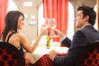 Couple toasting glasses in a restaurant