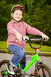 Photo: Child riding bike with safety helmet outdoors Child riding bike with safety helmet outdoors