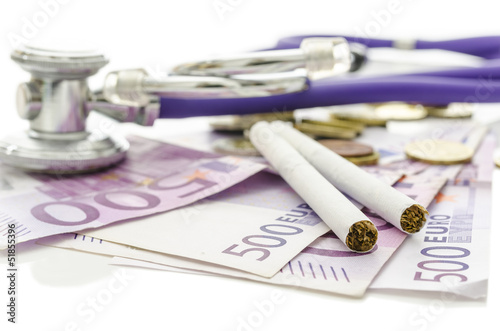 Photo: Ciarettes and stethoscope on Euro money Ciarettes and stethoscope on Euro money