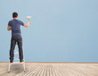 Man Painting On Blue Wall,Concept And Ideas