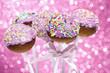 Pink cake pops decorated with colorful sprinkles