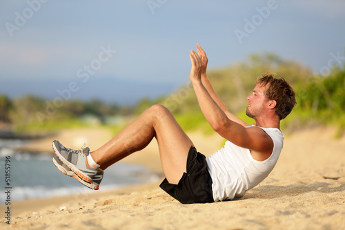 Photo: Sit ups - fitness crossfit man doing situps Sit ups - fitness crossfit man doing situps