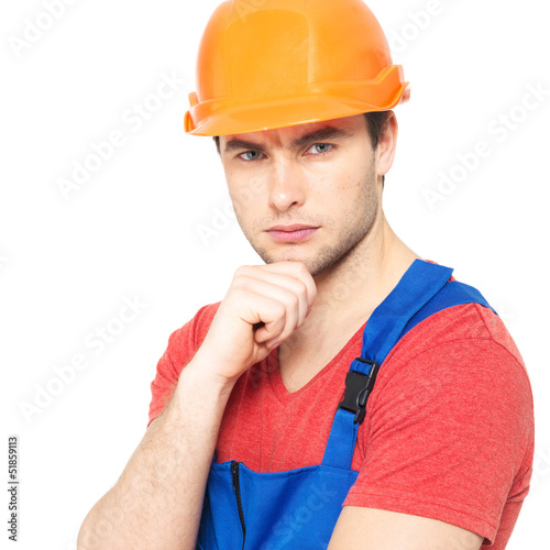 Photo: portrait of thinking handyman in uniform portrait of thinking handyman in uniform