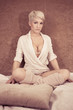 sensual women sitting on bed - colorized photo