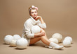 Embroidery. Woman in White Knitwear with Heap Balls of Yarn