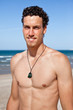 Handsome fit young man on the beach. Portrait