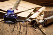 Photo: Blue inkwell and glasses surrounded by ancient messages and enve Blue inkwell and glasses surrounded by ancient messages and enve