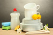 empty clean plates, glasses and cups with dishwashing liquid,