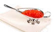 Red caviar in silver bowl isolated on white