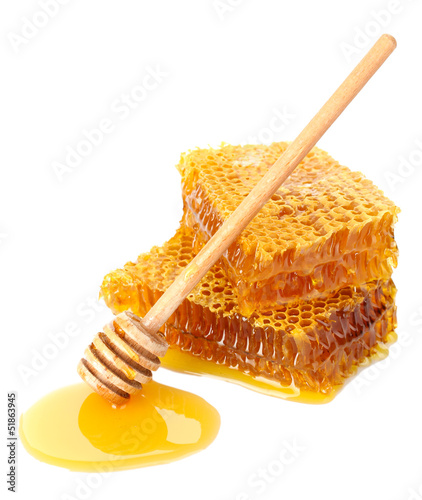 Photo: sweet honeycomb and wooden drizzler, isolated on white sweet honeycomb and wooden drizzler, isolated on white