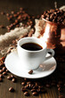 Cup of coffee and pot on wooden background