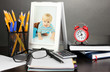 Photo: White photo frame on office desk on grey background White photo frame on office desk on grey background