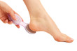 Photo: Woman having her foot scrubbed, isolated on white Woman having her foot scrubbed, isolated on white