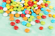 Photo: Colorful candies on green background Colorful candies on green background