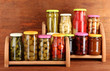 Different conservations on shelves on wooden background