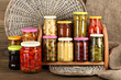 Different conservations on shelves on wooden background