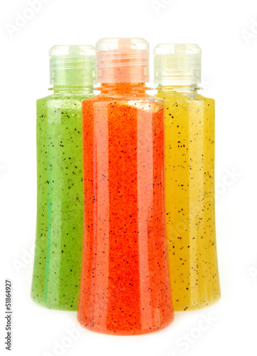 Photo: Bottles with scrub isolated on white Bottles with scrub isolated on white
