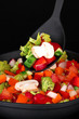 Vegetable ragout in pan, isolated on black