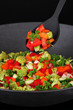 Vegetable ragout in wok, isolated on black