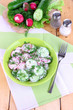 Vitamin vegetable salad in bowl on wooden table close-up